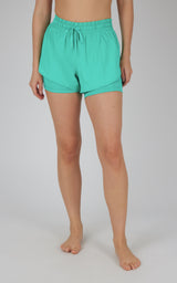 Women's teal lightweight running shorts with elastic waistband and drawstring closure.