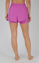 Women's lavender lightweight running shorts with layered fabric and elastic waistband.