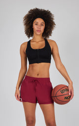 Women's lightweight maroon running shorts with adjustable drawstring and relaxed fit, paired with a black sports bra.
