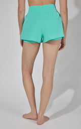 Women's mountain sage Lightstreme Love and Flutter running shorts with elastic waistband and curved hem.