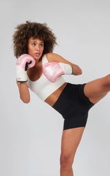 Woman wearing high-rise black 5-inch biker shorts with smooth, stretchy fabric and a wide waistband, paired with a white.
