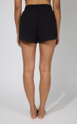 Women's black lounge shorts with a drawstring waist and a relaxed fit from the back.