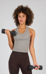 Heather gray ribbed racerback tank top with a fitted, sleeveless cut worn with dark brown leggings.