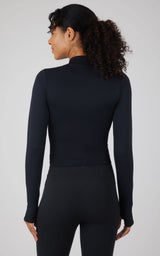 Black seamless long sleeve fitted top with mock neck on a female model seen from the back.