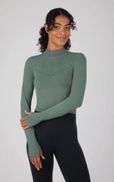 Dark forest green seamless long sleeve top with a textured chest panel and thumb holes.