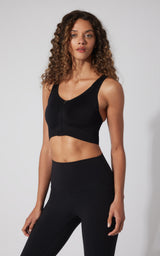 Black seamless full-zip sports bra with wide straps and scoop neckline.