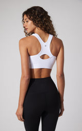 White seamless full zip sports bra with keyhole back and racerback straps.