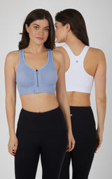 Two-piece set of women's seamless full-zip bras in light blue front and white racerback back, paired with black leggings.
