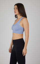 Light blue seamless full-zip sports bra with racerback and supportive fit.