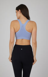 Light blue seamless full-zip sports bra with racerback design and smooth fabric.