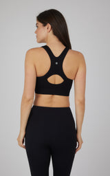 Black seamless full zip bra with racerback and cutout detail on back.