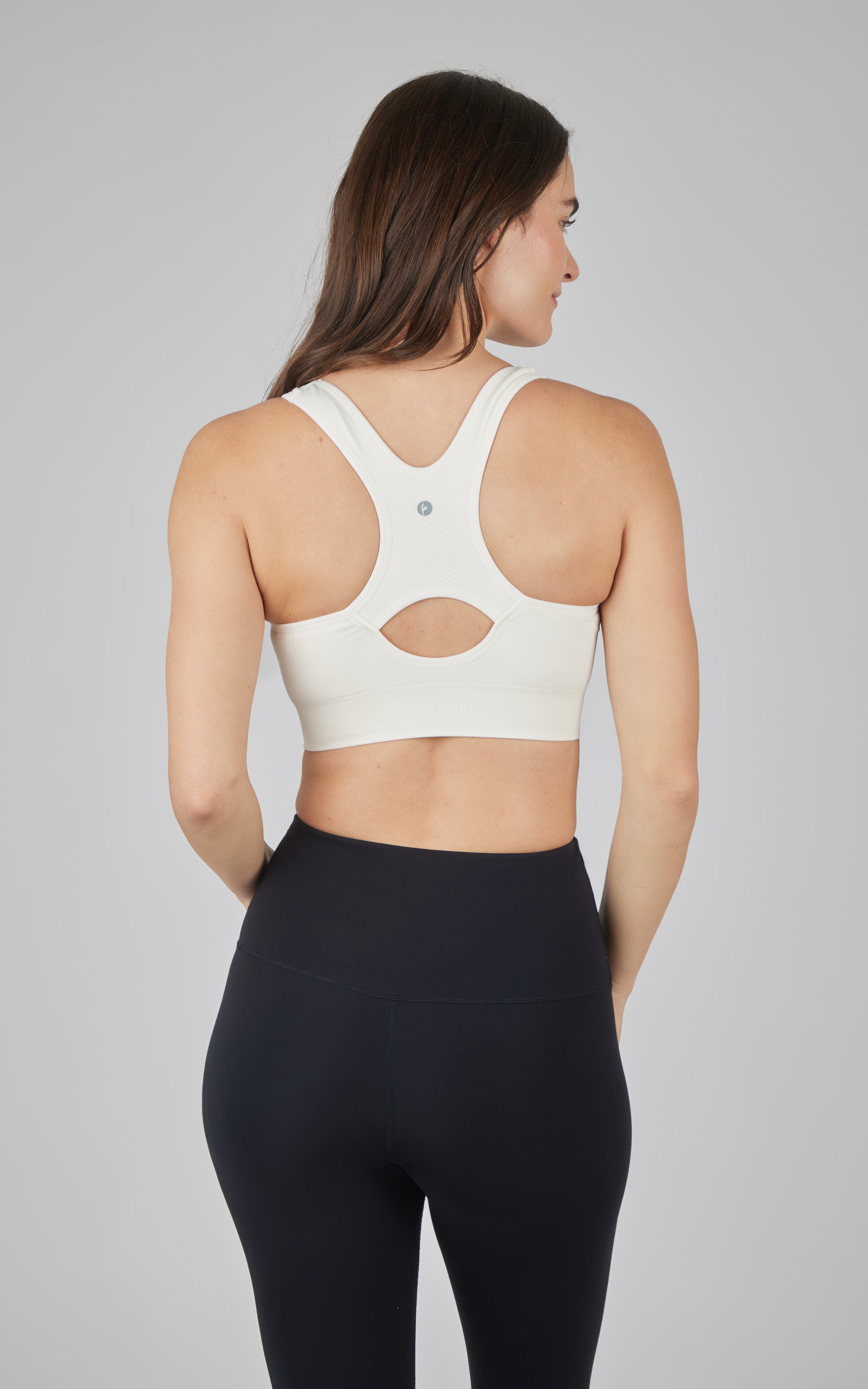 White seamless full zip bra with racerback and cutout detail on the back.