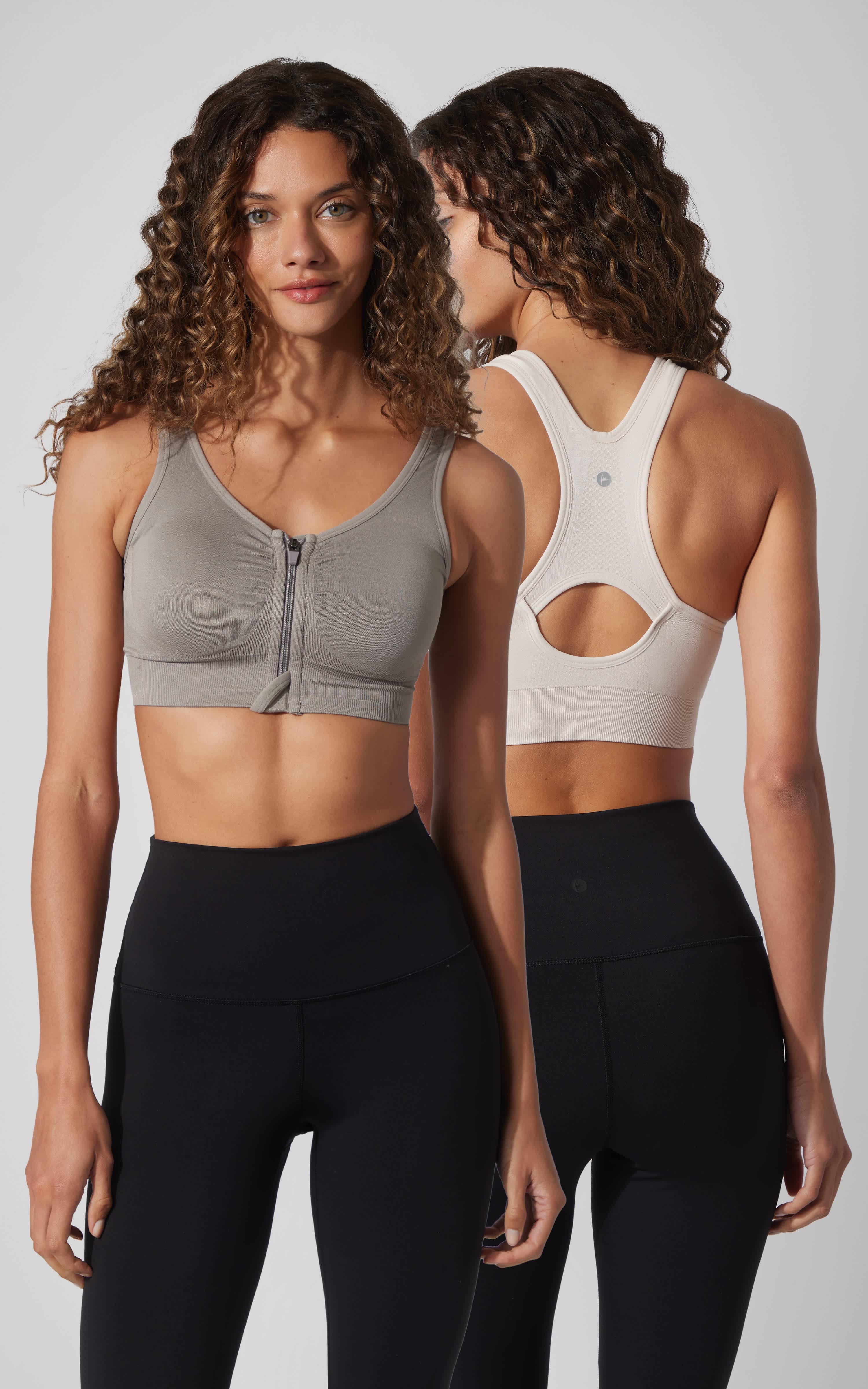 Seamless full zip sports bra in light gray front and white back with racerback cutout design.