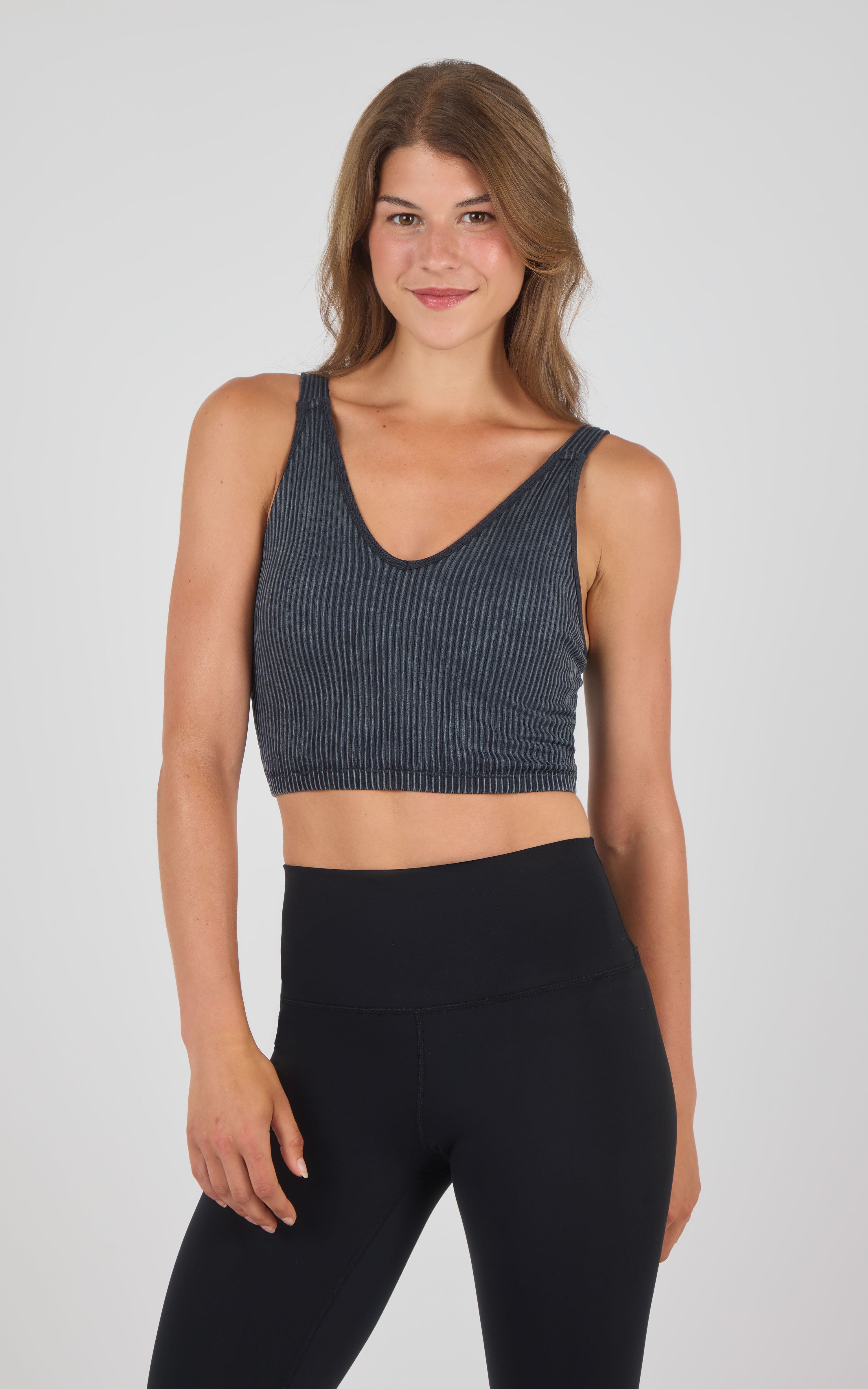 Seamless ribbed tank bra in dark stone wash with scoop neck and wide straps.
