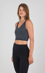 Seamless ribbed dark gray bra tank with wide straps and V-neck on woman.