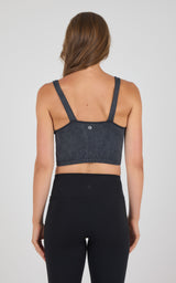 Black seamless ribbed bra tank with wide straps and a small logo on the back center.