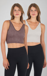 Two women wearing seamless ribbed Alamo bra tanks in brown and light gray, paired with black leggings.