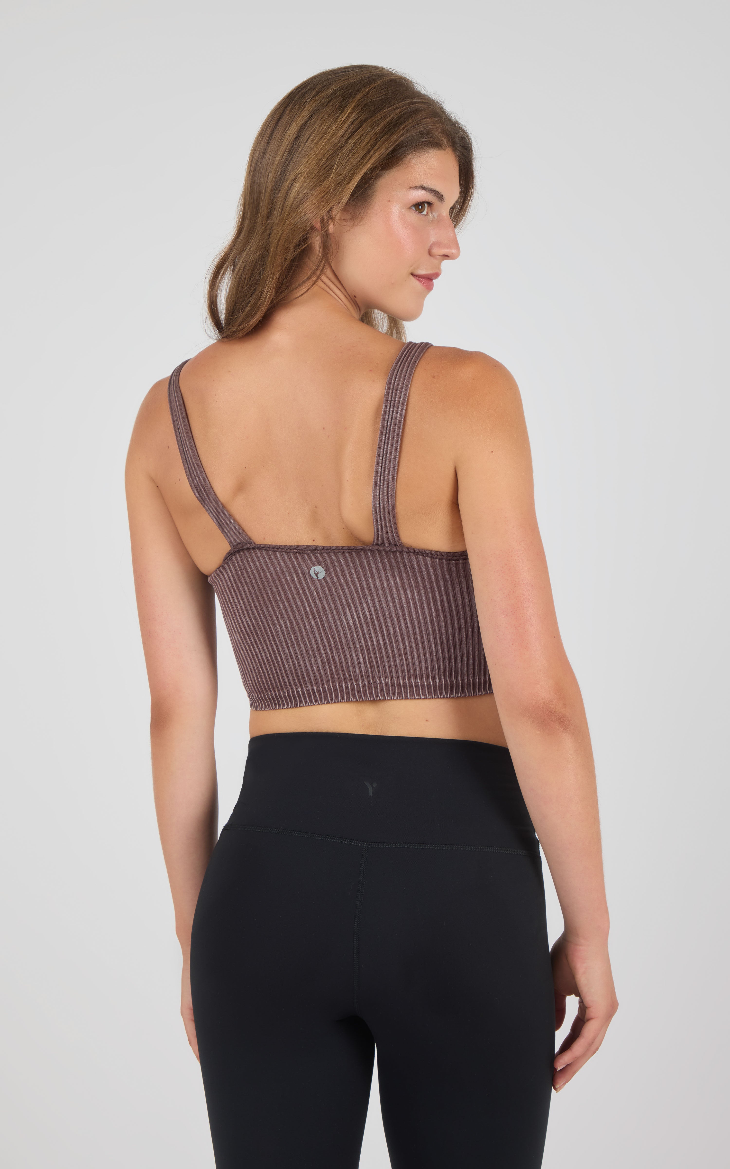 Seamless ribbed stone wash mauve bra tank with wide shoulder straps and racerback design.