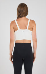 White seamless ribbed bra tank with adjustable straps and small back logo detailing.
