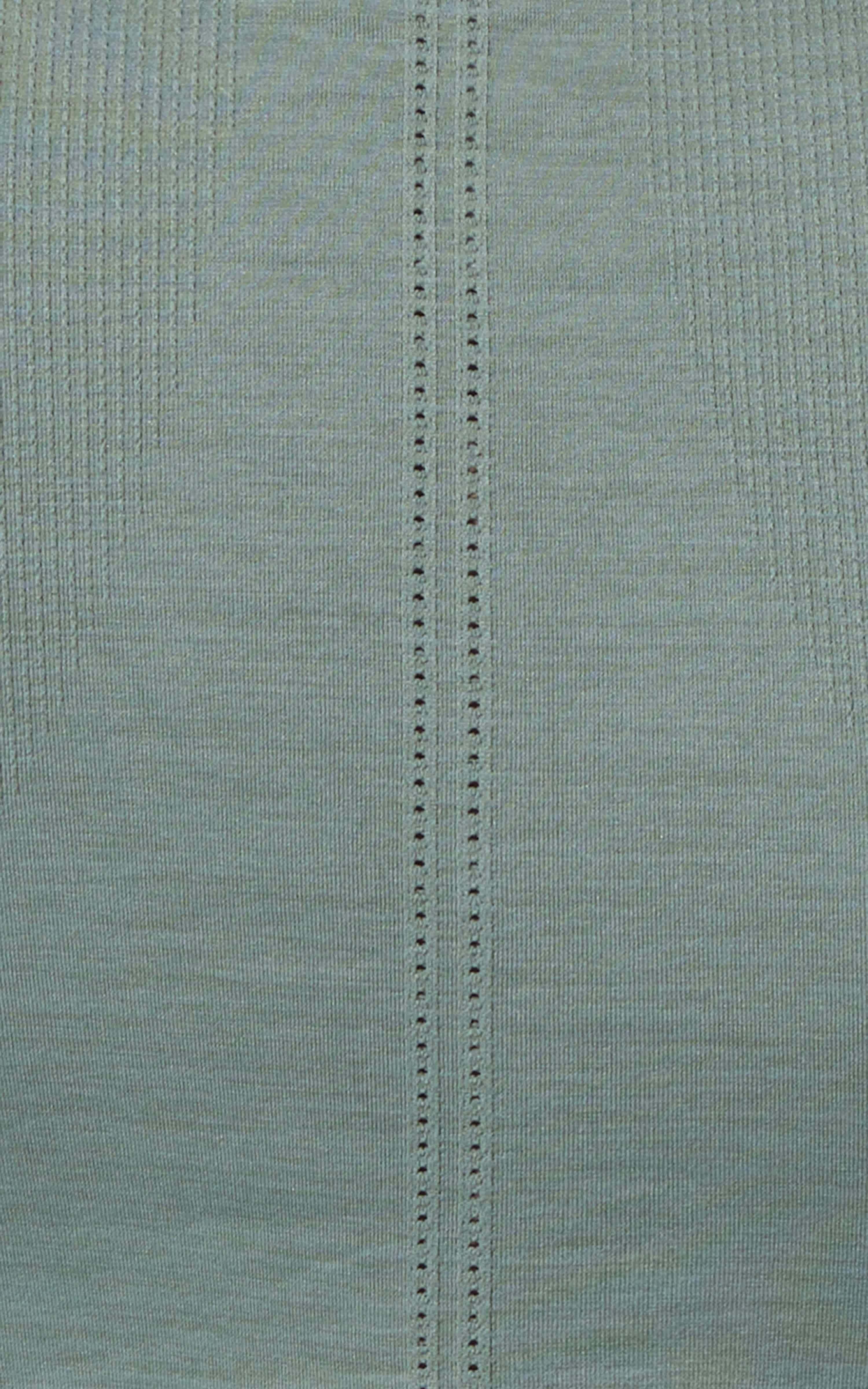 Close-up of green seamless fabric with vertical textured stitch detail.