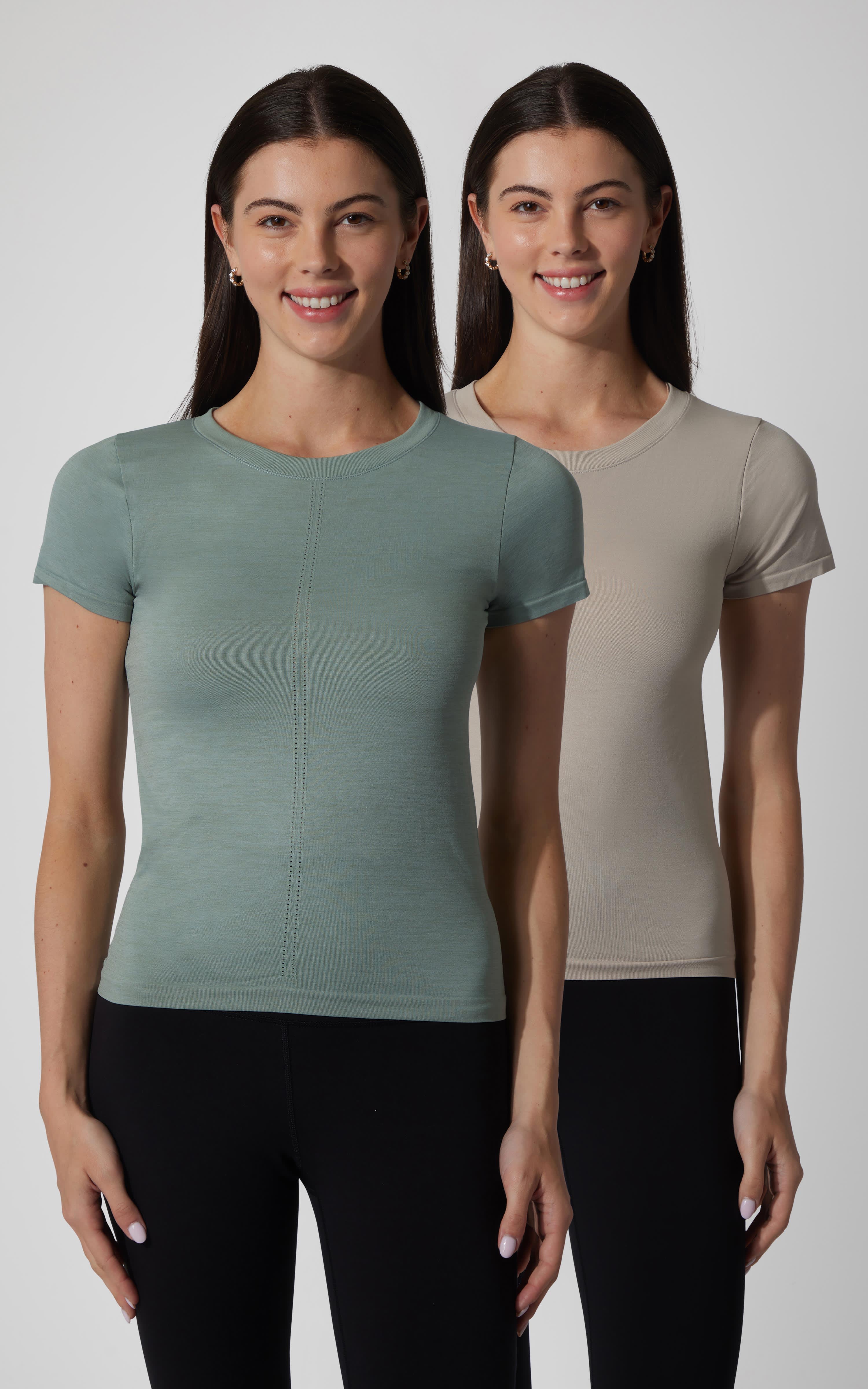 Two women wearing seamless short sleeve tees in muted green and light beige with fitted shapes and crew necklines.