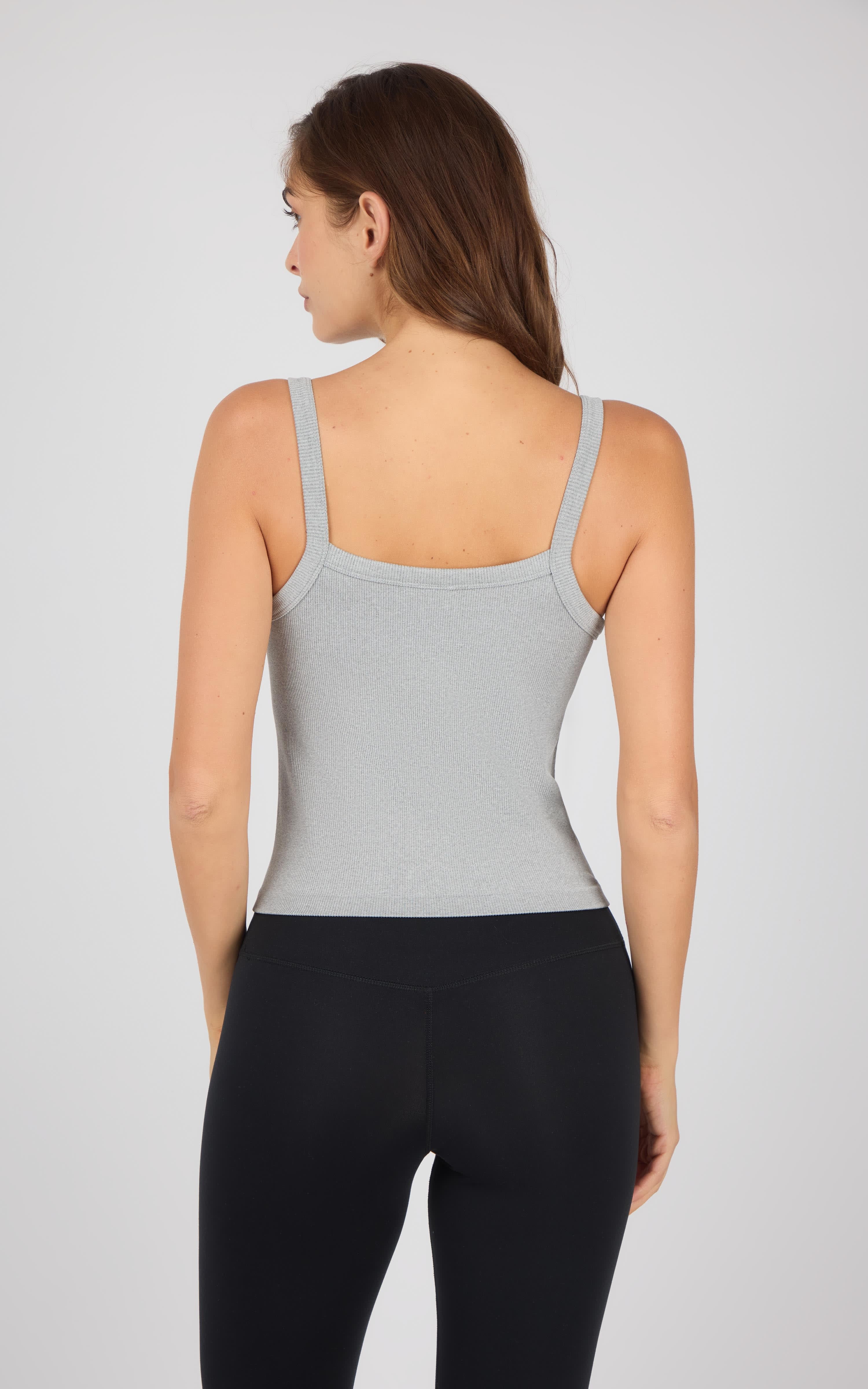 Light gray ribbed seamless tank top with thin straps on female model back view.