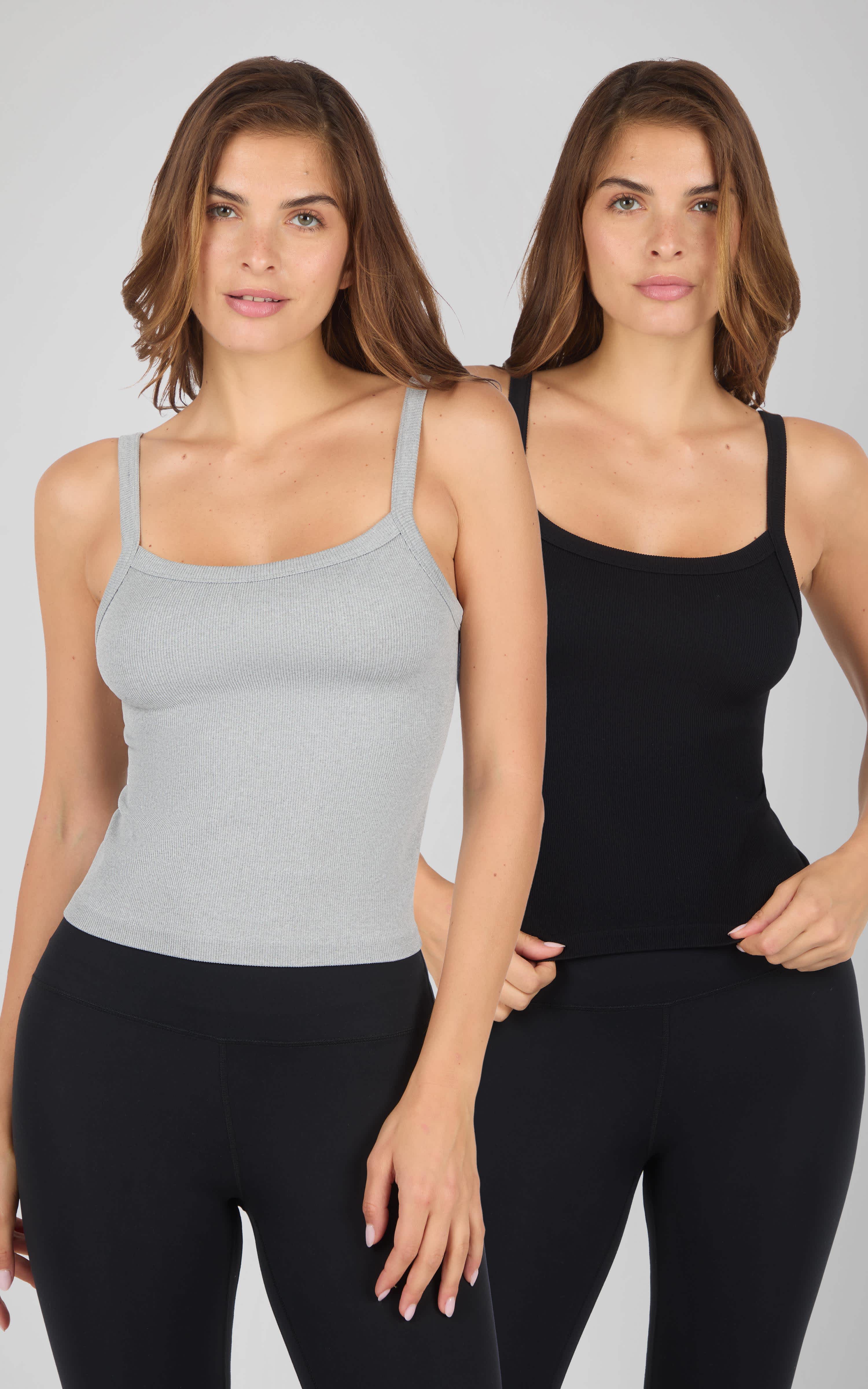 Two women wearing fitted ribbed seamless tank tops, one in light grey and the other in solid black, with thin straps.