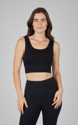 Black seamless cable knit bra top with wide straps and scoop neckline on female model.