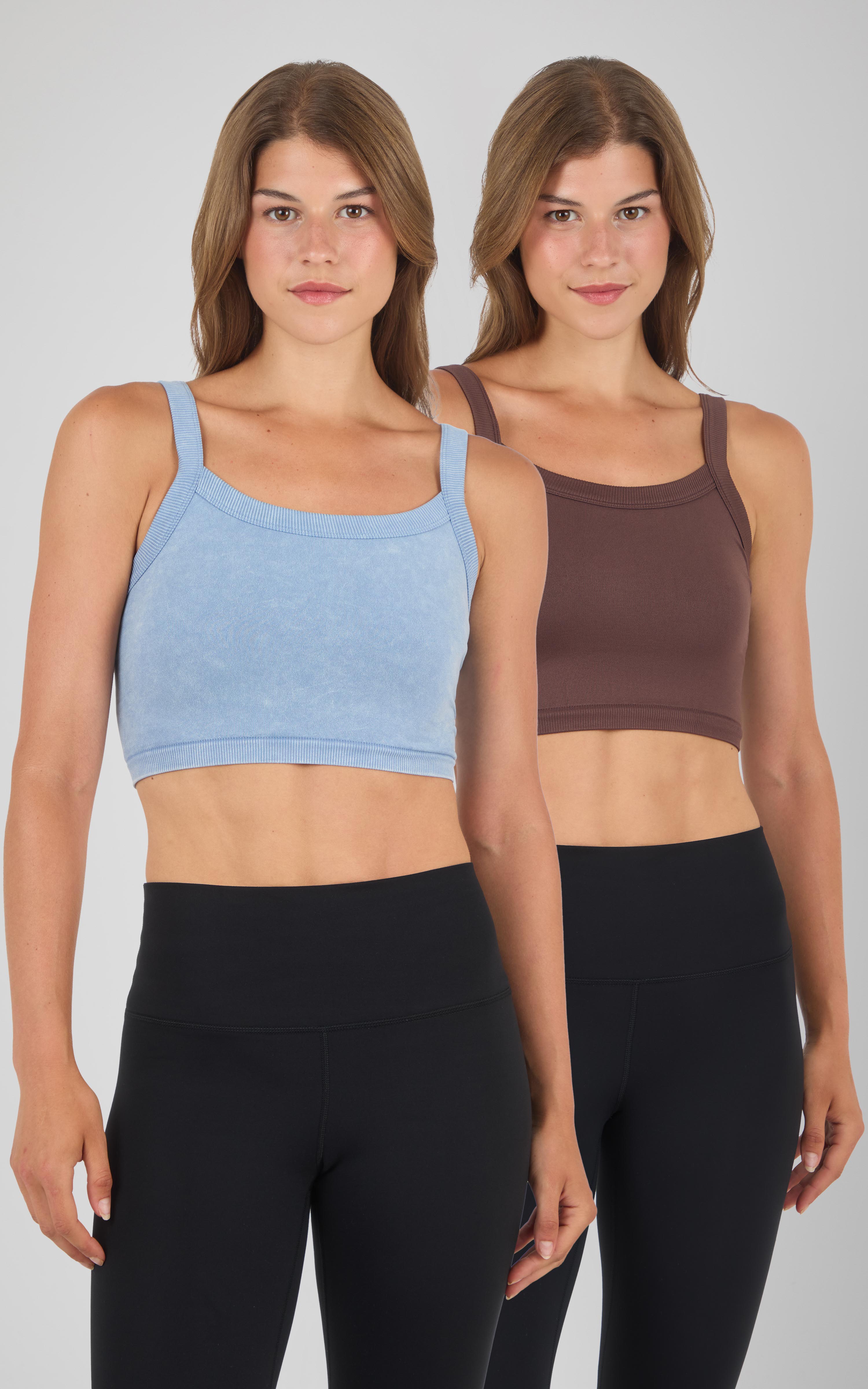 Two women wearing seamless bra tank tops in light blue and chocolate brown, paired with black leggings.
