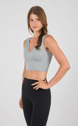 Heather grey seamless longline bra with wide straps and smooth finish worn with black leggings.