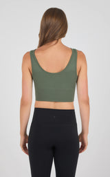 Seamless olive green bra with wide straps and low scoop back shown on a female model.