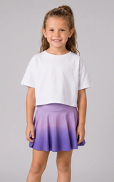 Girl wearing white cropped t-shirt and purple to violet dip dye flare skort.