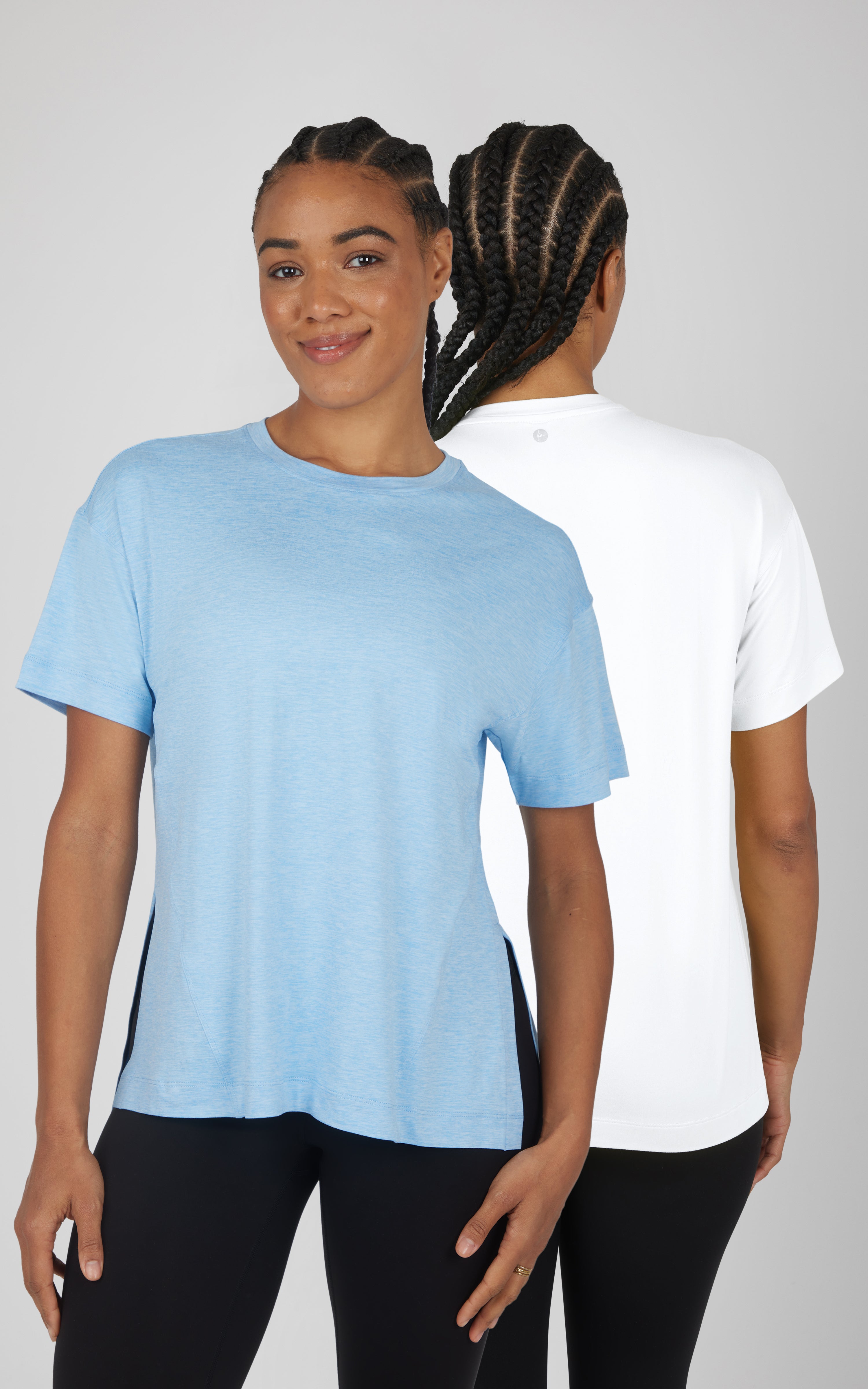 Two super-soft crewneck T-shirts, one light blue and one white, with short sleeves and a relaxed hi-low hem.