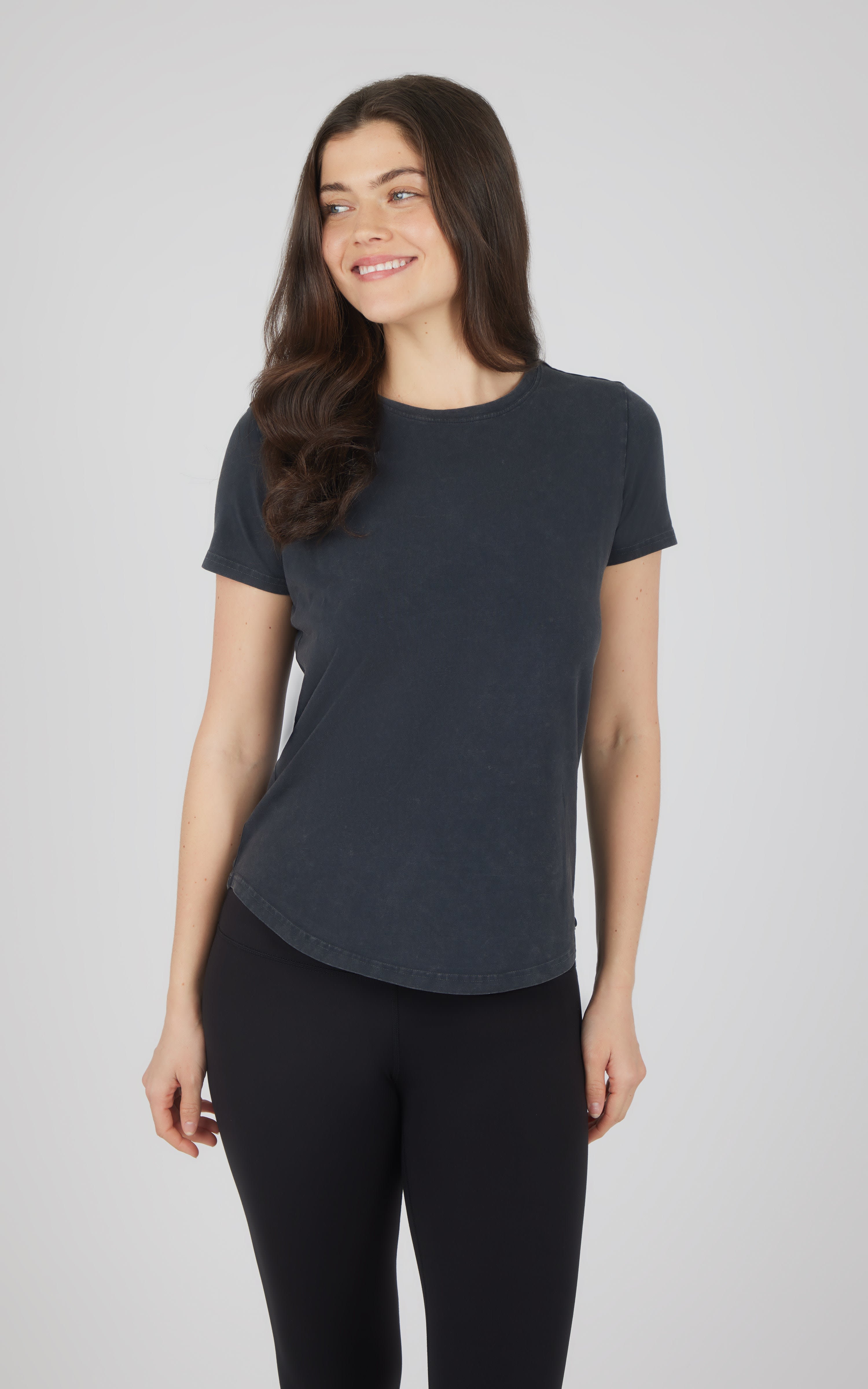 Women's acid wash black cotton jersey crew neck short sleeve tee with curved hem.