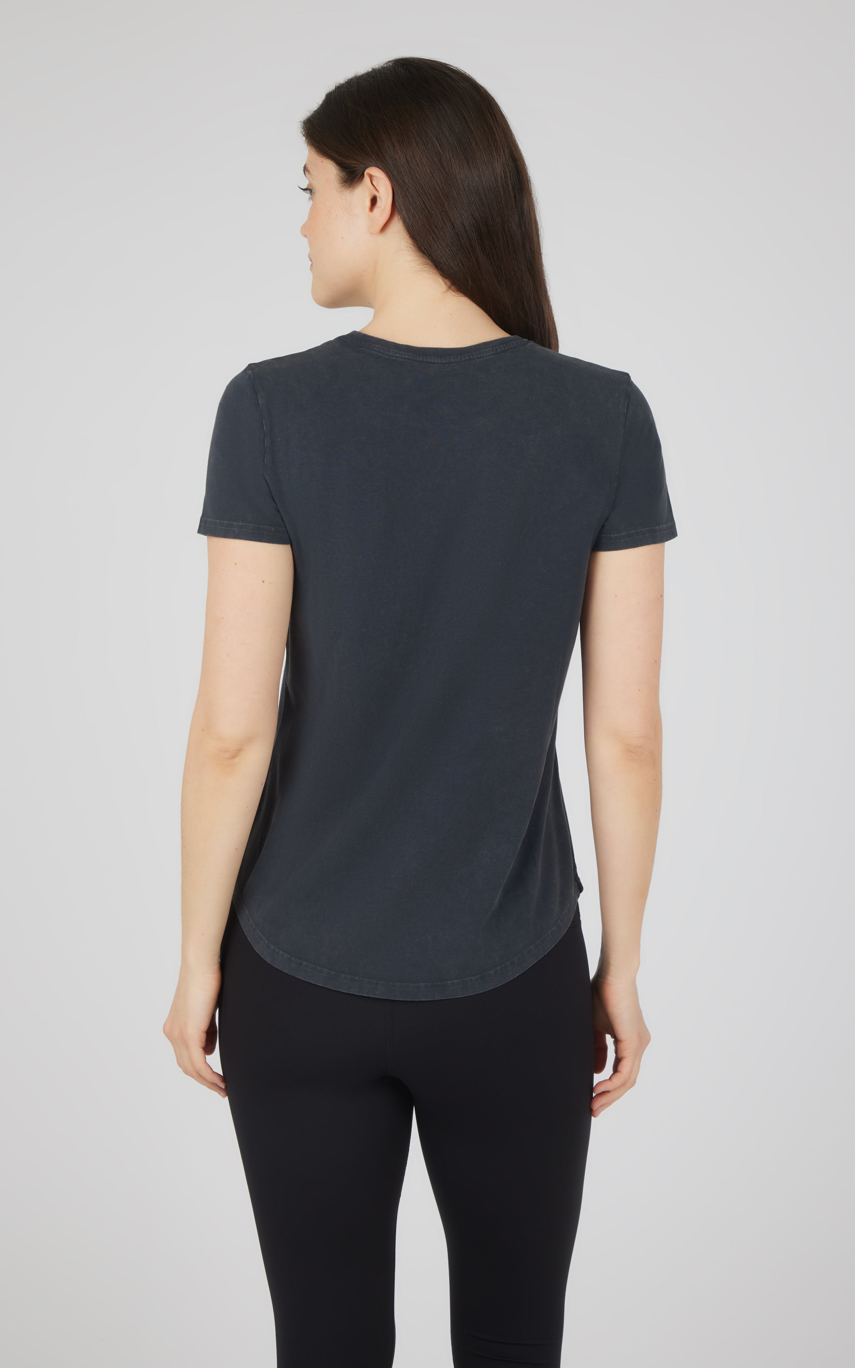 Women's short-sleeve black cotton jersey crew neck tee shown from back.