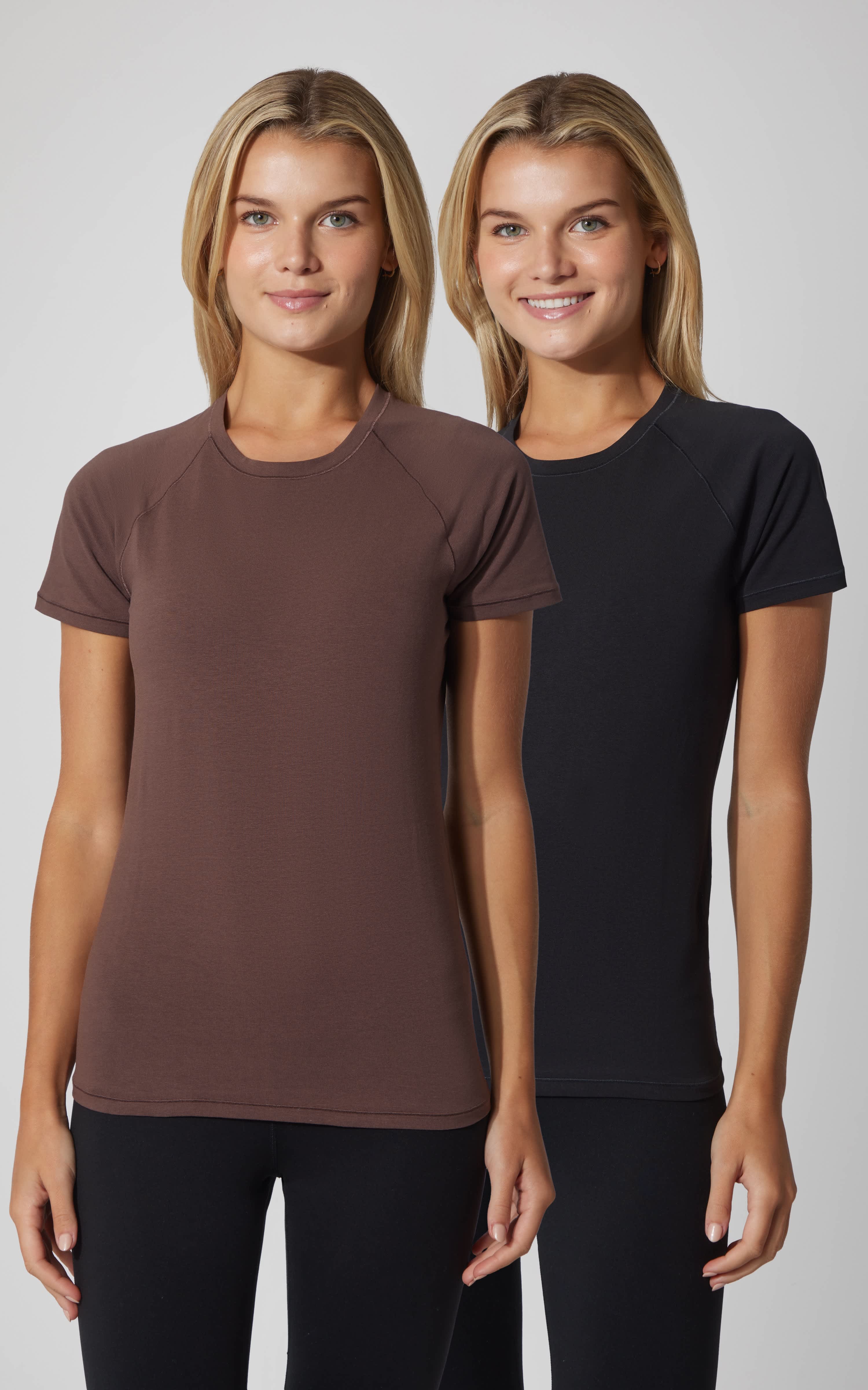 Two women wearing vintage cotton crew neck short sleeve tops in classic brown and shadow rock black, slim fit.