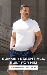Man in white t-shirt and blue shorts standing on steps "summer essentials built for him shop mens collection"