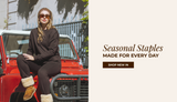Model wearing a dark brown matching lounge set and shearling boots, sitting on the hood of a red vintage SUV. Text reads “Seasonal Staples, Made for Every Day” with a “Shop New In” button.