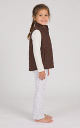 Toddler wearing a brown quilted vest over a white long-sleeve top with light gray flared pants.
