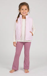 Toddler wearing a pale pink quilted vest over a cream long-sleeve top with mauve flare pants.