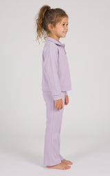 Toddler girl wearing a lavender long-sleeve half-zip top and matching flared pants, shown in side profile.