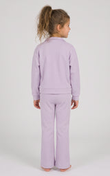 Back view of a toddler girl wearing a lavender half-zip sweatshirt and matching slim-fit flare pants.