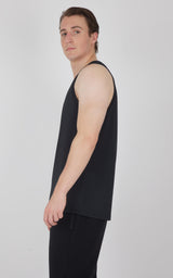 Black men's muscle tank with wide armholes and a relaxed fit shown from side angle.
