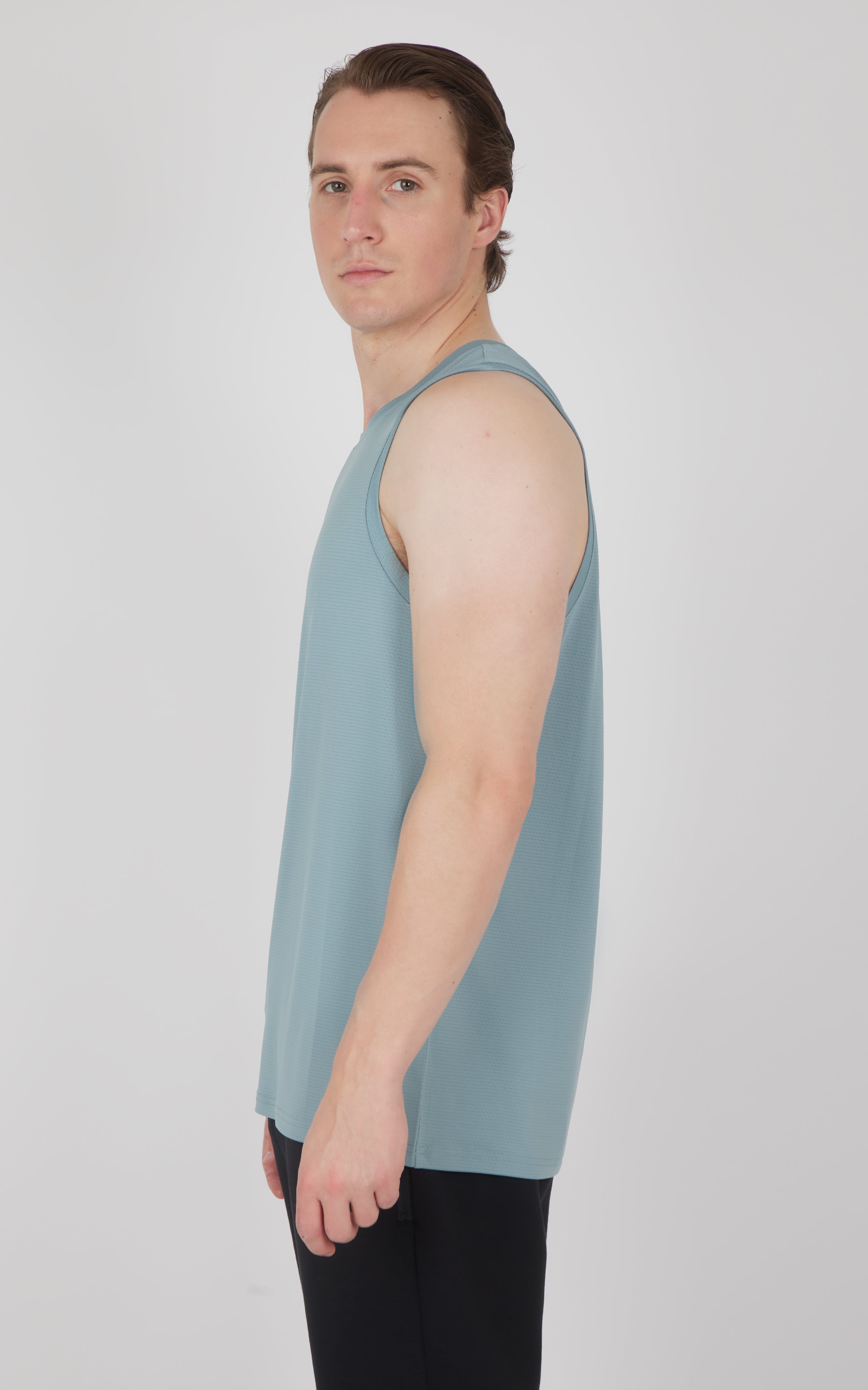 Men's sleeveless muscle tank in muted blue with a relaxed fit and round neckline.