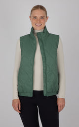 Dark forest green quilted vest with high collar, sleeveless design, worn over beige long sleeve top.