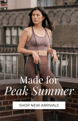 A woman wearing a matching mauve-brown activewear set stands on an outdoor balcony with a brick building in the background. Text on the right reads 'Made for Peak Summer' and 'SHOP NEW ARRIVALS'.