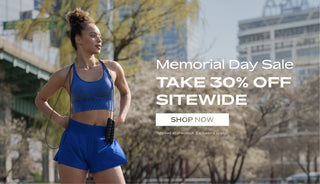 Woman in athletic wear holding jump ropes with Memorial Day sale text overlay. 30% Off Sitewide