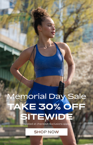 Woman in athletic wear holding jump ropes with Memorial Day sale text overlay. 30% Off Sitewide