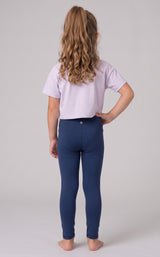 Back view of a girl wearing full-length navy leggings with a smooth, stretchy fit and a lavender top.