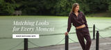 Woman wearing a matching burgundy cropped sweatshirt and jogger set standing on a wooden dock beside a green pond, with text reading “Matching Looks for Every Moment” and a “Shop Matching Sets” button.